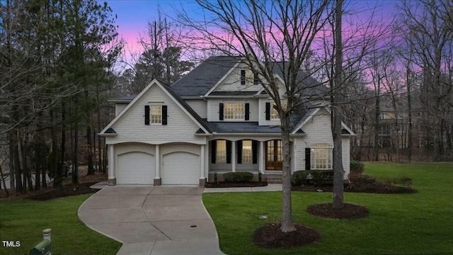 view of front of house with a porch, a front lawn, and concrete driveway