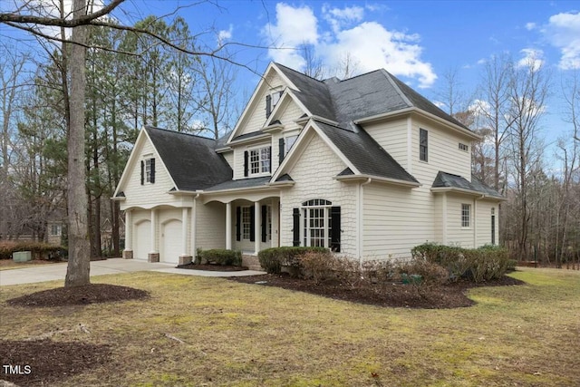 view of front facade featuring driveway, a garage, a shingled roof, covered porch, and a front yard