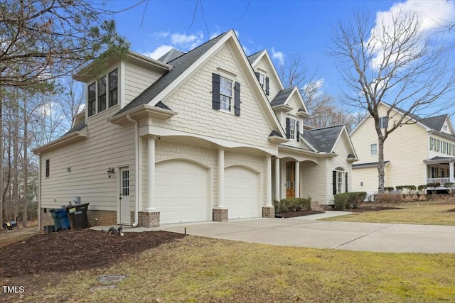 view of front of home with a garage, driveway, and a front lawn