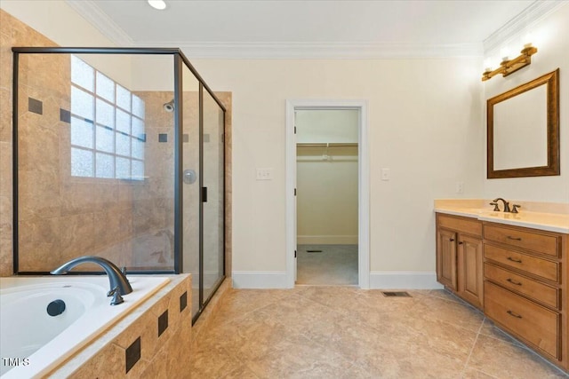 bathroom featuring a stall shower, a spacious closet, ornamental molding, and vanity