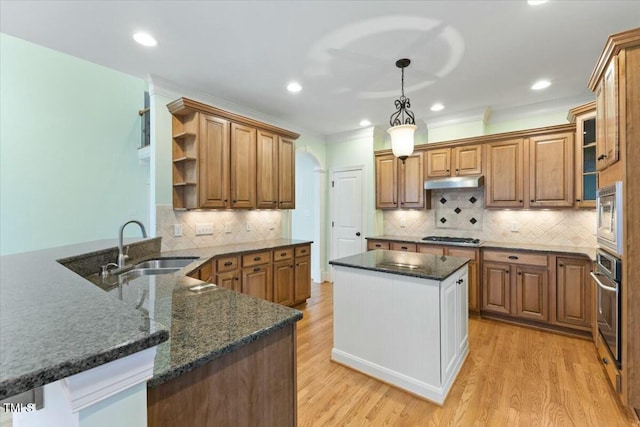 kitchen featuring a peninsula, open shelves, pendant lighting, and brown cabinets