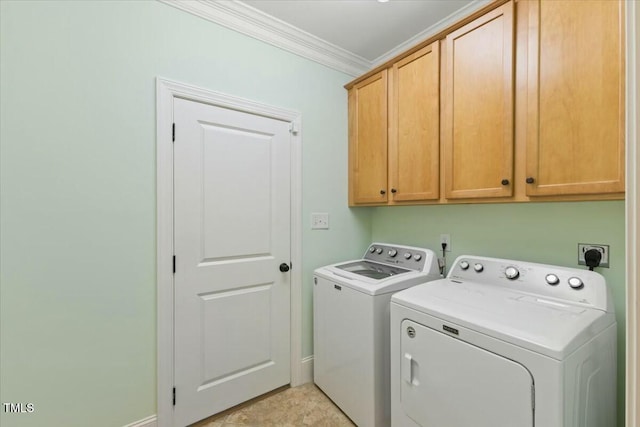 washroom with independent washer and dryer, cabinet space, and crown molding