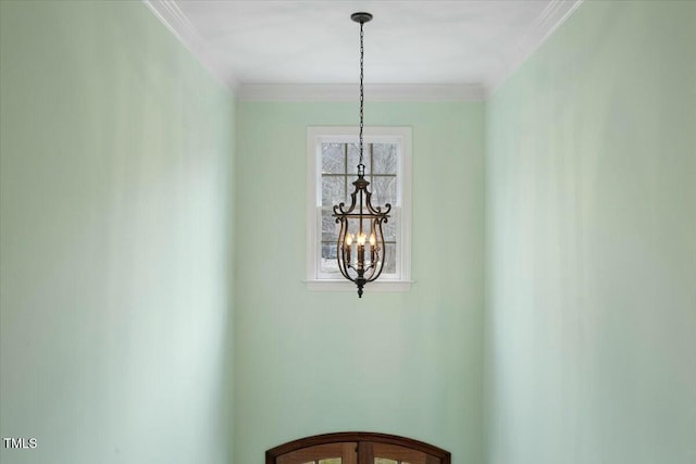 room details with ornamental molding and a chandelier