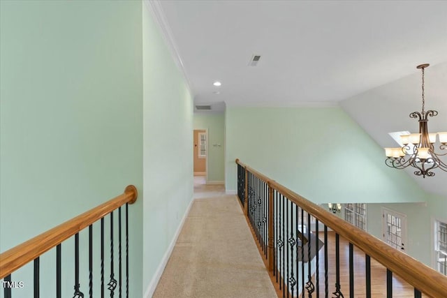 hallway with visible vents, baseboards, light colored carpet, an upstairs landing, and a notable chandelier