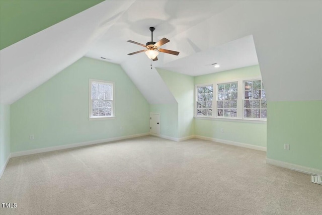 additional living space with a ceiling fan, lofted ceiling, light carpet, and baseboards