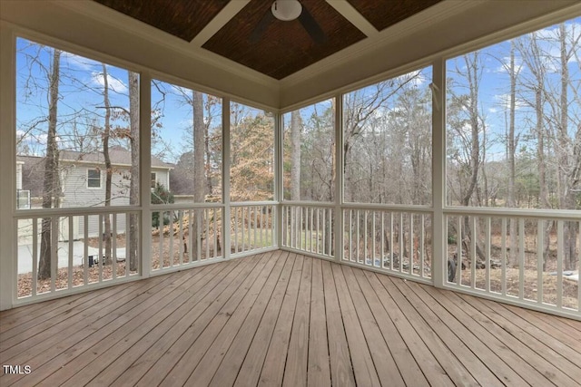 unfurnished sunroom featuring a ceiling fan