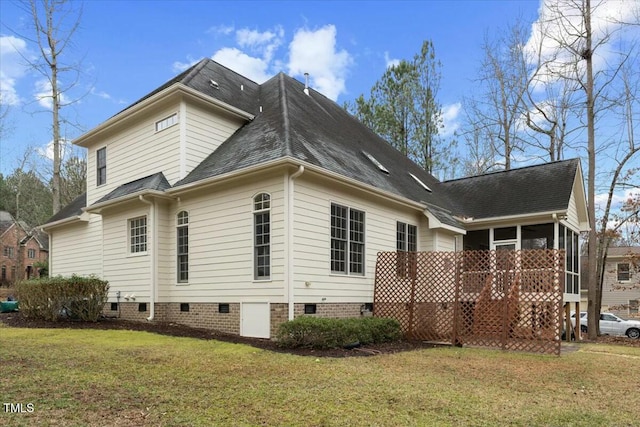 back of property with a yard, a shingled roof, crawl space, and a sunroom