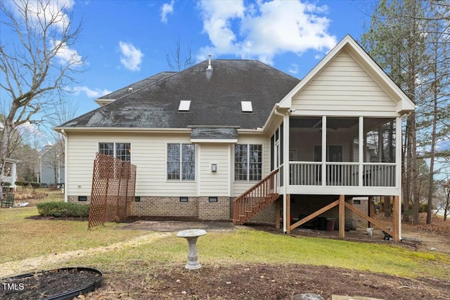 back of house featuring a shingled roof, a sunroom, crawl space, stairs, and a yard