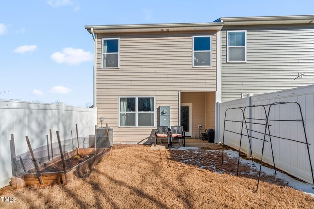 back of house with a garden, central AC, fence, and a patio