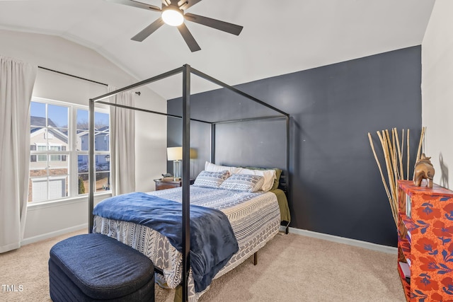 bedroom with a ceiling fan, light colored carpet, vaulted ceiling, and baseboards