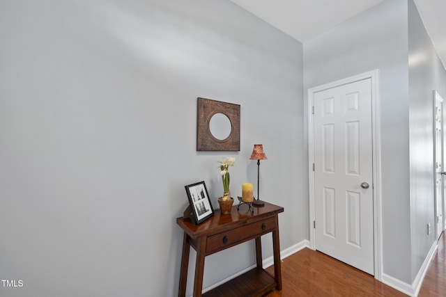 interior space featuring wood finished floors and baseboards