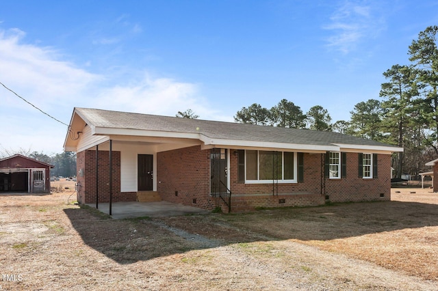 view of front of home featuring crawl space and brick siding