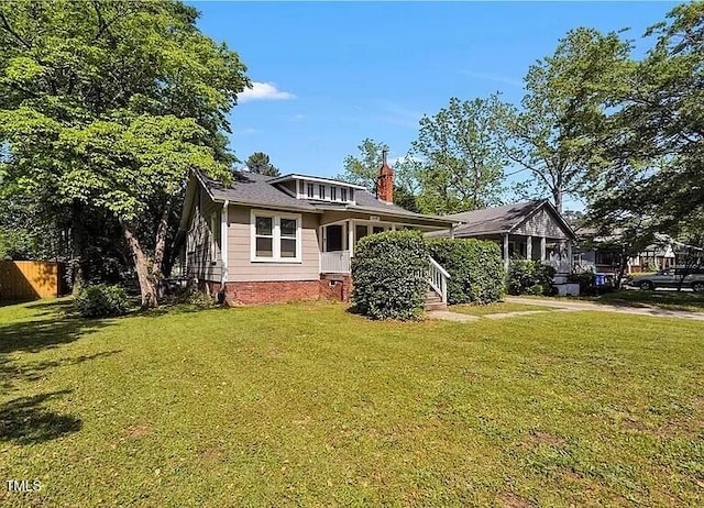 exterior space with crawl space, fence, and a front lawn