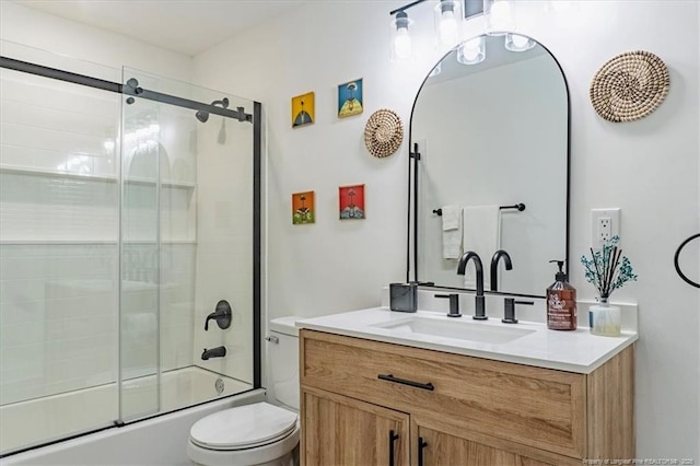 bathroom featuring toilet, bath / shower combo with glass door, and vanity