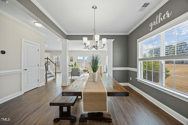 dining space featuring baseboards, visible vents, dark wood-style flooring, crown molding, and ornate columns