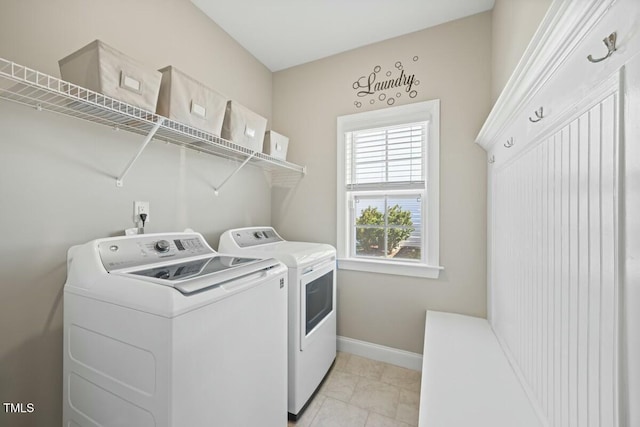 laundry room with washer and dryer, laundry area, and baseboards