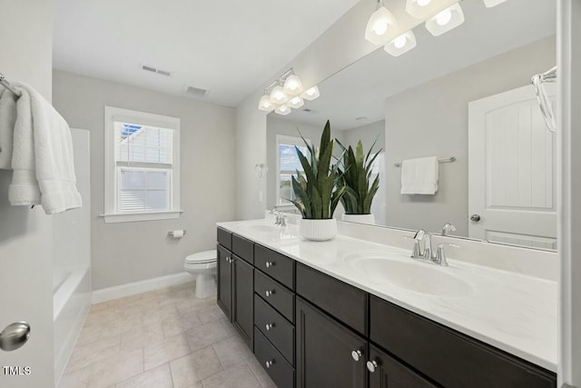 bathroom with visible vents, a sink, toilet, and baseboards