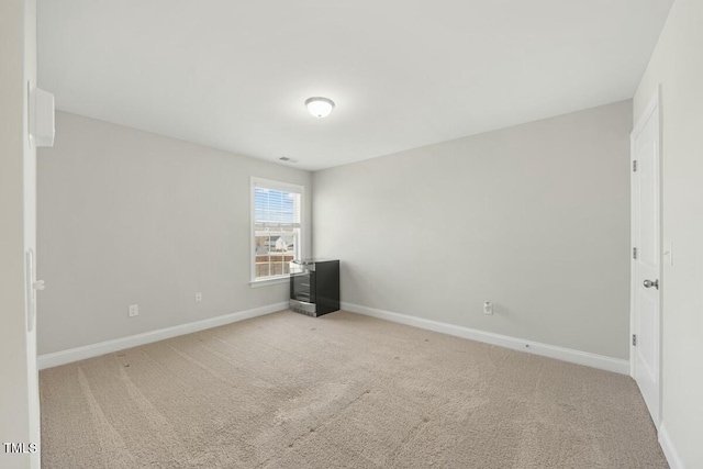 unfurnished bedroom featuring baseboards and light colored carpet