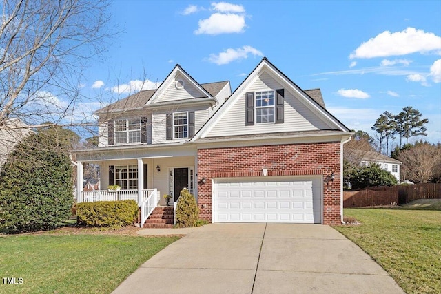 traditional-style house featuring brick siding, covered porch, concrete driveway, a front yard, and a balcony