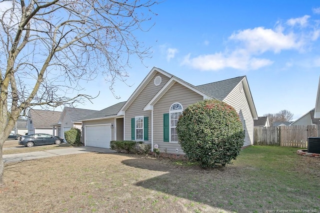 single story home featuring a garage, a shingled roof, fence, concrete driveway, and a front lawn