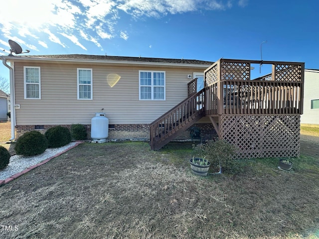 back of house with a deck, crawl space, a yard, and stairway