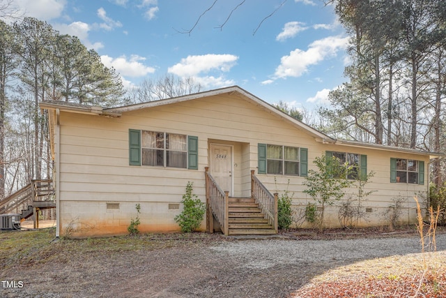 view of front of house with entry steps, crawl space, central AC, and stairs