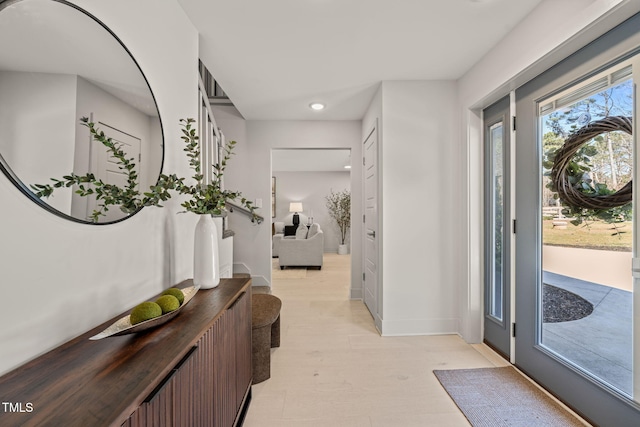 entryway with light wood-style flooring and baseboards