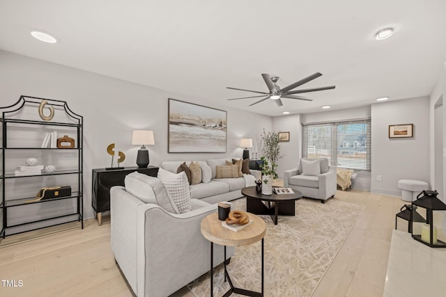 living room featuring light wood-style floors, recessed lighting, ceiling fan, and baseboards