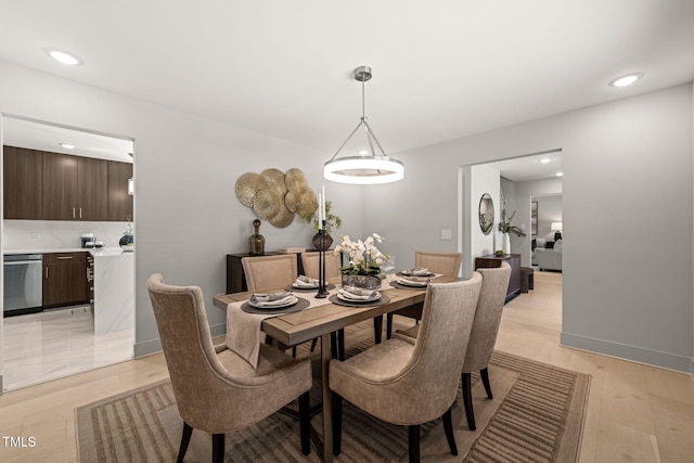 dining room featuring baseboards, recessed lighting, and light wood-style floors