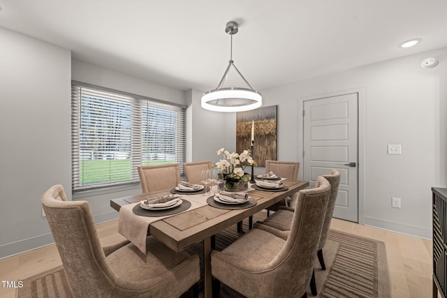 dining area with baseboards, recessed lighting, and light wood-style floors