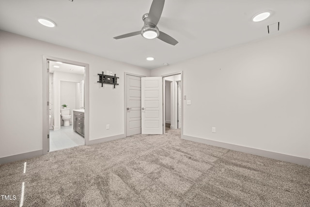 unfurnished bedroom with carpet floors, visible vents, baseboards, and ensuite bathroom