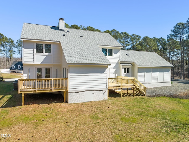 rear view of property with a yard, crawl space, a wooden deck, and roof with shingles