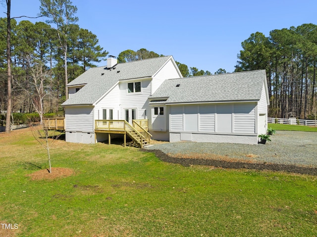 rear view of property featuring a yard, a chimney, a shingled roof, crawl space, and a wooden deck