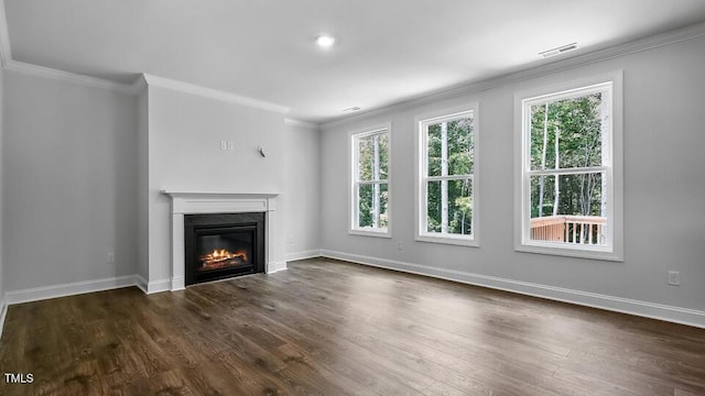7521 Percussion Dr, Apex, NC 27539 - unfurnished living room featuring ornamental molding, healthy amount of natural light, a glass covered fireplace, and dark wood-style floors