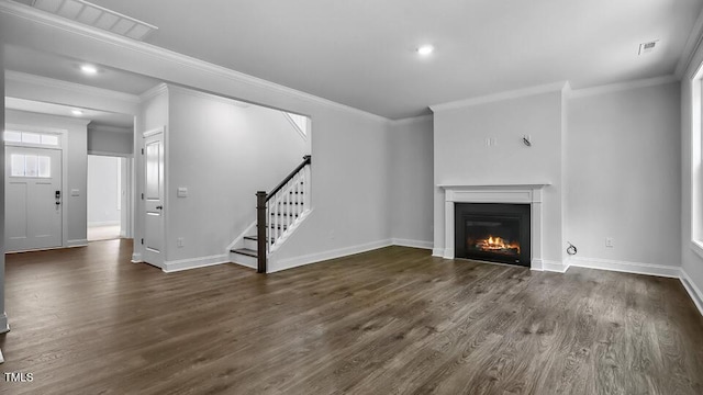 7521 Percussion Dr, Apex, NC 27539 - unfurnished living room with stairway, crown molding, wood finished floors, a glass covered fireplace, and recessed lighting