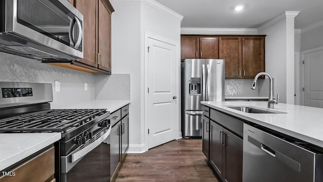 7521 Percussion Dr, Apex, NC 27539 - kitchen with appliances with stainless steel finishes, dark wood finished floors, crown molding, decorative backsplash, and dark brown cabinets