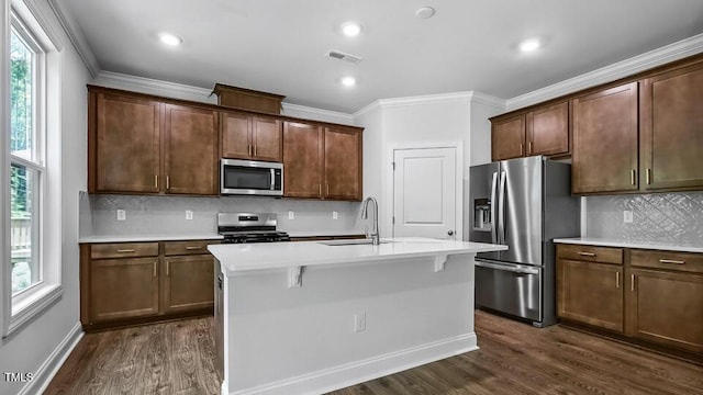7521 Percussion Dr, Apex, NC 27539 - kitchen with stainless steel appliances, dark wood-type flooring, decorative backsplash, light countertops, and ornamental molding