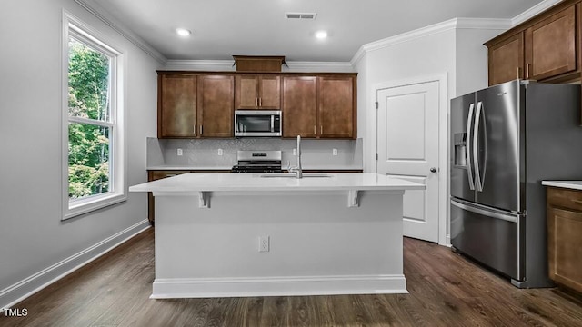 7521 Percussion Dr, Apex, NC 27539 - kitchen featuring stainless steel appliances, plenty of natural light, decorative backsplash, light countertops, and ornamental molding
