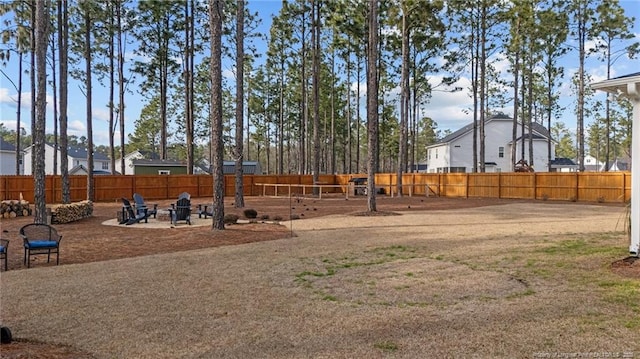 view of yard featuring a fire pit and a fenced backyard