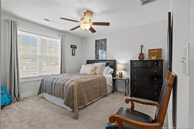 bedroom with ceiling fan, visible vents, and light colored carpet