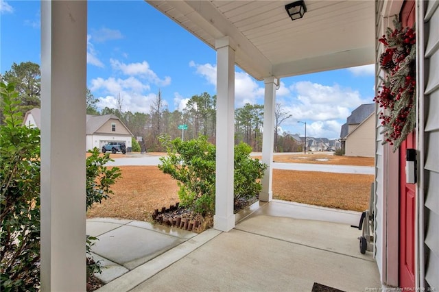 view of patio with a residential view and a porch