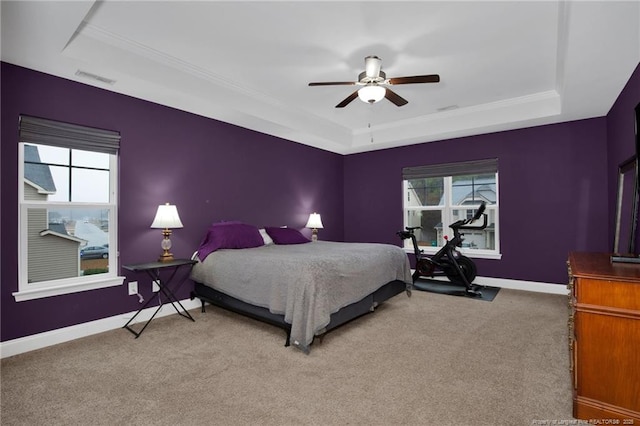 carpeted bedroom featuring a raised ceiling, visible vents, and baseboards