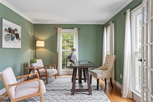 interior space with crown molding, light wood-style flooring, and baseboards