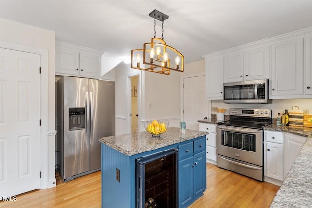 kitchen featuring blue cabinets, wine cooler, appliances with stainless steel finishes, and white cabinetry