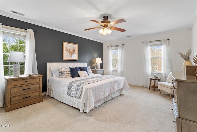 bedroom featuring visible vents, light carpet, baseboards, and crown molding