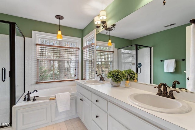 bathroom with a sink, visible vents, a garden tub, and a stall shower