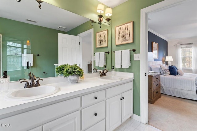 ensuite bathroom featuring double vanity, visible vents, ensuite bath, and a sink