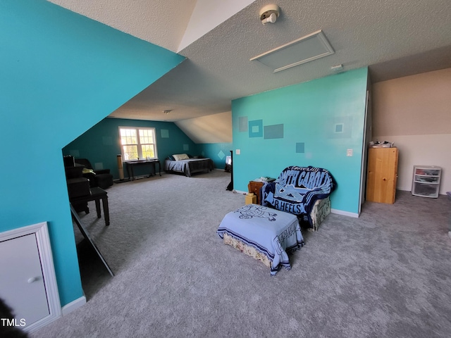 bedroom featuring a textured ceiling, baseboards, vaulted ceiling, carpet, and attic access