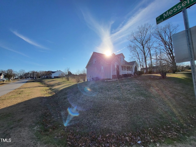 view of property exterior with a yard