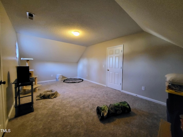 bonus room with lofted ceiling, visible vents, a textured ceiling, and baseboards